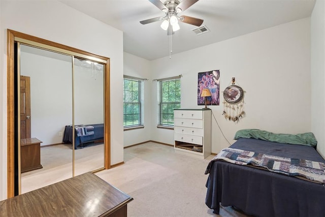 14601 Billy Dr, Edmond, OK 73034 - bedroom with light colored carpet, a ceiling fan, and a closet