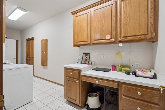 14601 Billy Dr, Edmond, OK 73034 - home office featuring washer / dryer, built in desk, and light tile patterned flooring