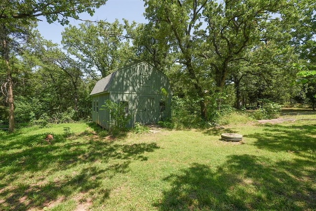 14601 Billy Dr, Edmond, OK 73034 - view of green lawn featuring an outdoor structure, a fire pit, and a barn
