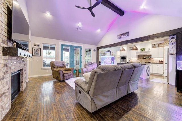 14716 Turkey Hills Rd, Newalla, OK 74857 - living area featuring high vaulted ceiling, a ceiling fan, dark wood-type flooring, beamed ceiling, and a fireplace