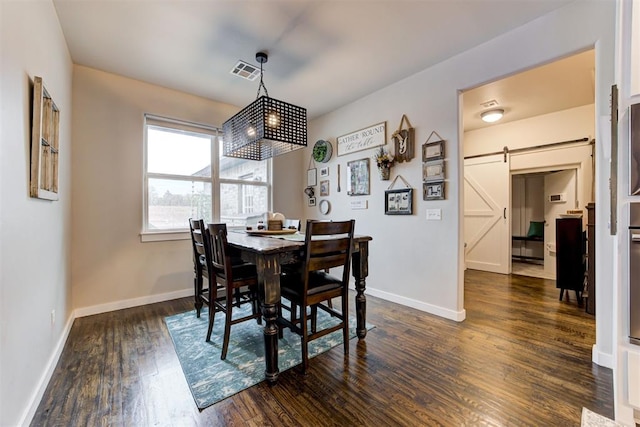 14716 Turkey Hills Rd, Newalla, OK 74857 - dining room featuring a barn door and dark wood-type flooring