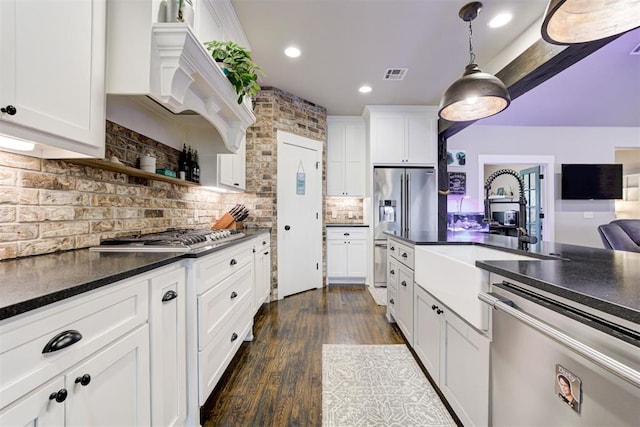 14716 Turkey Hills Rd, Newalla, OK 74857 - kitchen with stainless steel appliances, dark countertops, white cabinetry, backsplash, and recessed lighting