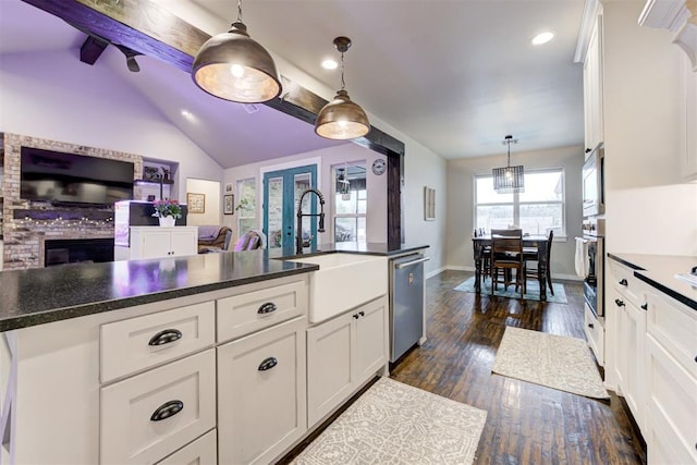 14716 Turkey Hills Rd, Newalla, OK 74857 - kitchen featuring stainless steel appliances, white cabinets, open floor plan, dark countertops, and recessed lighting