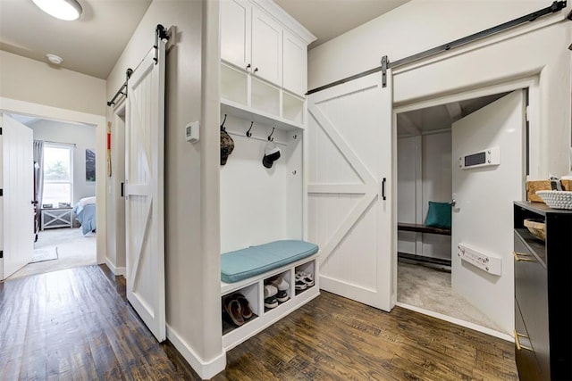 14716 Turkey Hills Rd, Newalla, OK 74857 - mudroom with a barn door and dark wood-style floors
