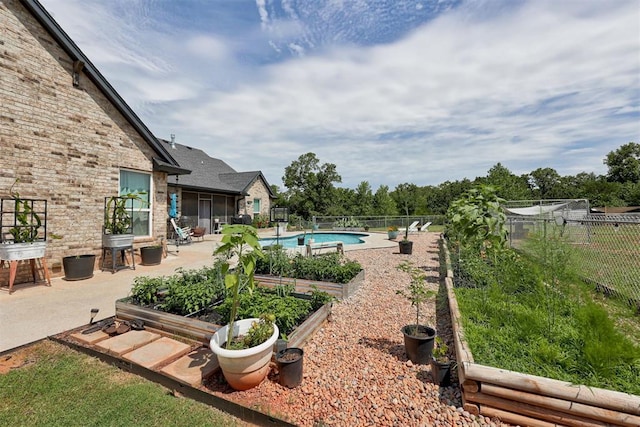 14716 Turkey Hills Rd, Newalla, OK 74857 - fenced backyard featuring a vegetable garden and a patio