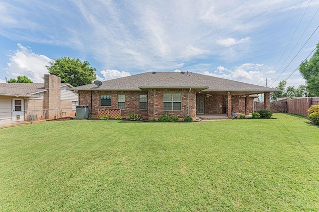 105 Kimberling Dr, Moore, OK 73160 - rear view of property featuring brick siding, a fenced backyard, and a shingled roof
