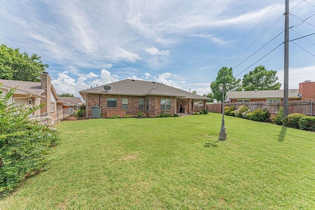 105 Kimberling Dr, Moore, OK 73160 - back of property featuring a fenced backyard and brick siding