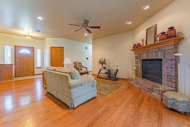 105 Kimberling Dr, Moore, OK 73160 - living area with light wood-type flooring, a ceiling fan, a brick fireplace, and recessed lighting