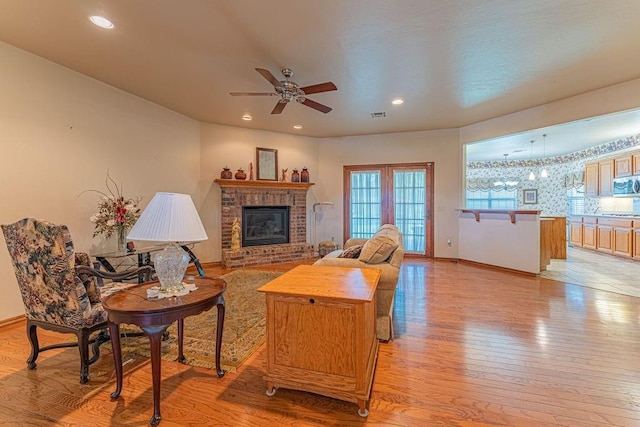 105 Kimberling Dr, Moore, OK 73160 - living area featuring ceiling fan, light wood-type flooring, a brick fireplace, and recessed lighting