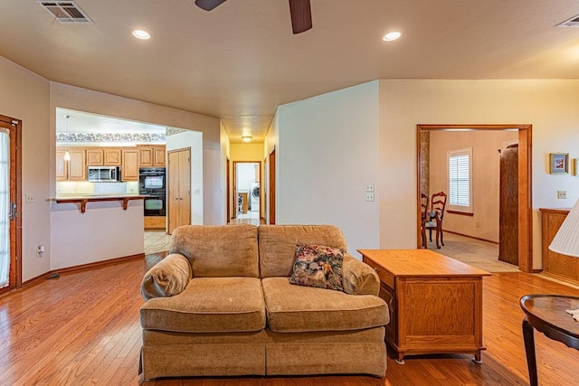 105 Kimberling Dr, Moore, OK 73160 - living room with light wood-type flooring, a ceiling fan, recessed lighting, and washer / clothes dryer