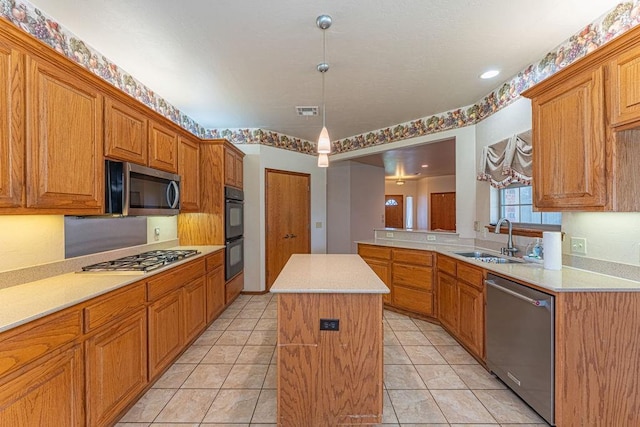 105 Kimberling Dr, Moore, OK 73160 - kitchen featuring stainless steel appliances, light countertops, and a kitchen island