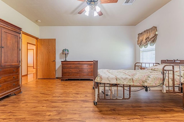 105 Kimberling Dr, Moore, OK 73160 - bedroom with wood finished floors and a ceiling fan