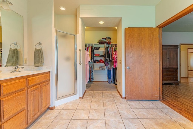 105 Kimberling Dr, Moore, OK 73160 - bathroom featuring a shower stall, a spacious closet, vanity, tile patterned floors, and recessed lighting