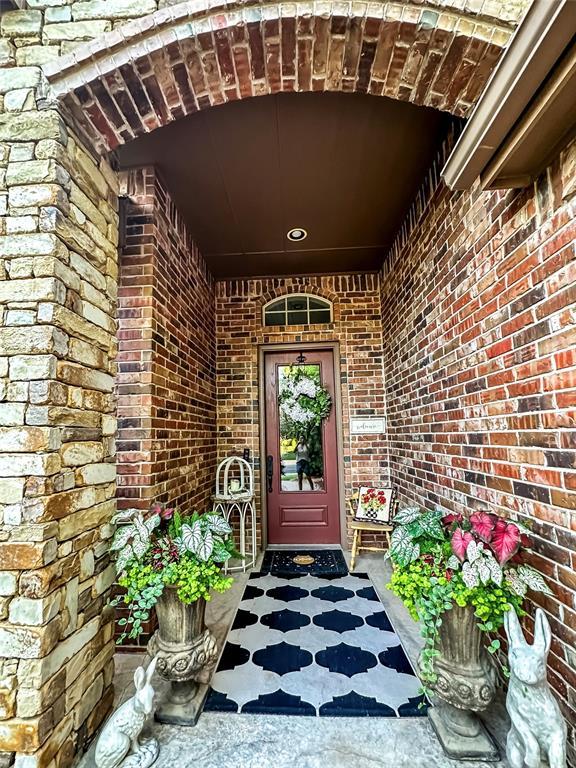 16721 Village Garden Dr, Edmond, OK 73012 - doorway to property with brick siding