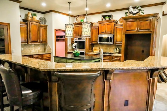 16721 Village Garden Dr, Edmond, OK 73012 - kitchen featuring appliances with stainless steel finishes, a large island, ornamental molding, decorative backsplash, and a kitchen breakfast bar