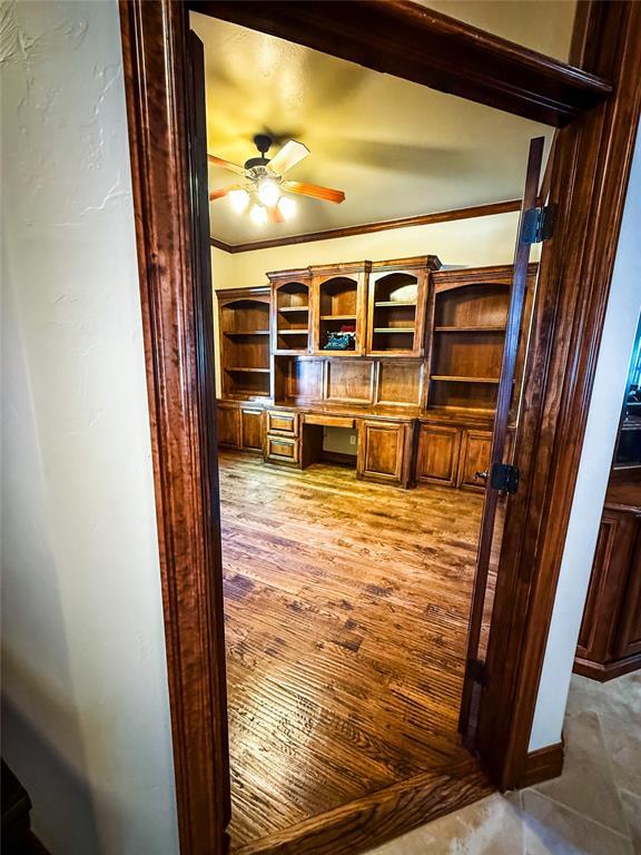 16721 Village Garden Dr, Edmond, OK 73012 - bar area featuring a ceiling fan, built in study area, and light wood finished floors