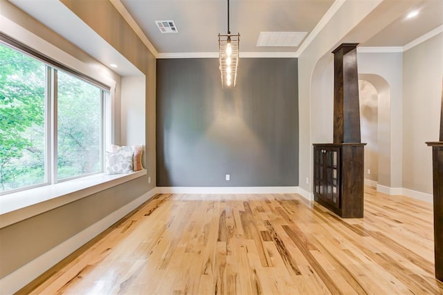 7600 Walk In The Park Dr, Edmond, OK 73034 - spare room with arched walkways, crown molding, and wood finished floors