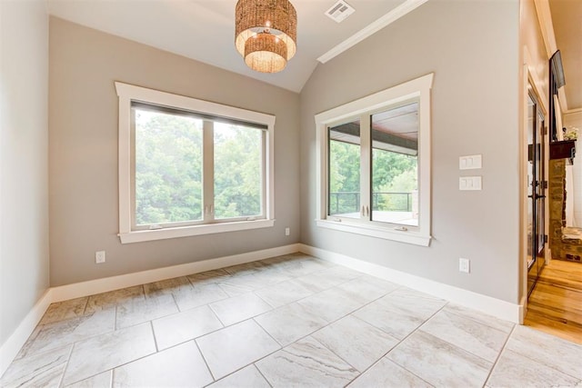 7600 Walk In The Park Dr, Edmond, OK 73034 - empty room with plenty of natural light, lofted ceiling, crown molding, and a chandelier