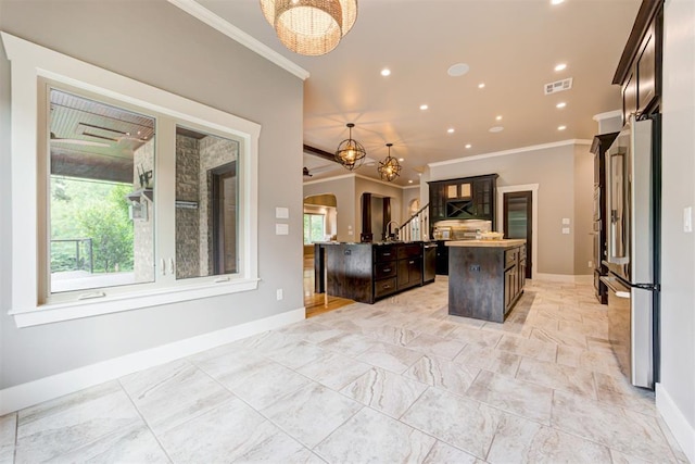 7600 Walk In The Park Dr, Edmond, OK 73034 - kitchen with freestanding refrigerator, ornamental molding, a kitchen island with sink, a chandelier, and recessed lighting