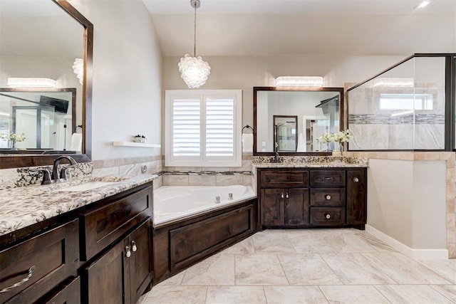 7600 Walk In The Park Dr, Edmond, OK 73034 - bathroom with two vanities, a garden tub, a tile shower, and a chandelier