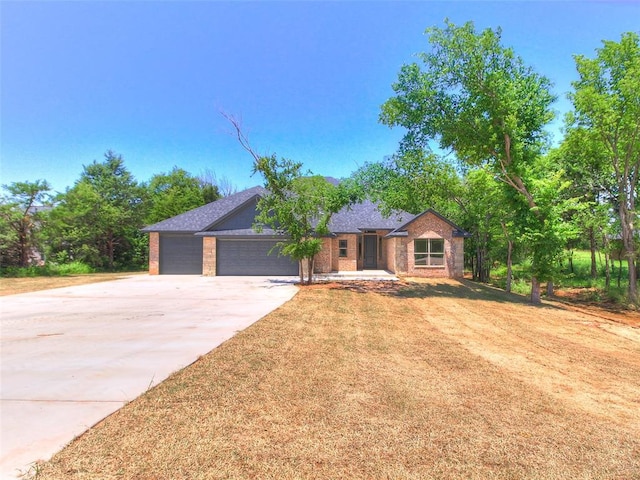 9070 Oak Tree Cir, Edmond, OK 73025 - single story home with concrete driveway, a garage, and brick siding