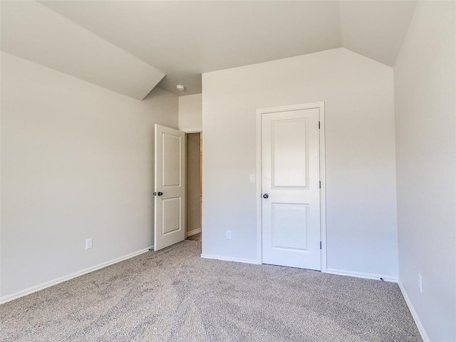 9070 Oak Tree Cir, Edmond, OK 73025 - unfurnished bedroom featuring carpet floors and lofted ceiling