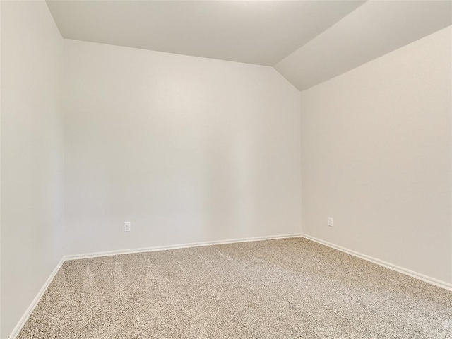 9070 Oak Tree Cir, Edmond, OK 73025 - spare room featuring carpet and lofted ceiling