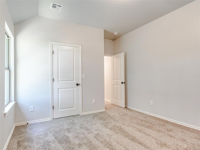 9070 Oak Tree Cir, Edmond, OK 73025 - unfurnished bedroom with carpet floors and vaulted ceiling