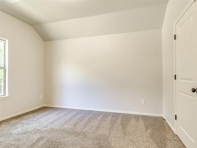 9070 Oak Tree Cir, Edmond, OK 73025 - carpeted spare room featuring vaulted ceiling and plenty of natural light