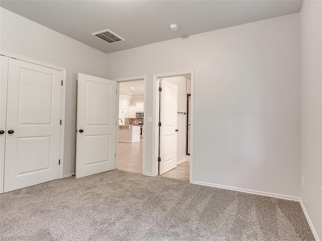 9070 Oak Tree Cir, Edmond, OK 73025 - unfurnished bedroom featuring carpet flooring and a closet
