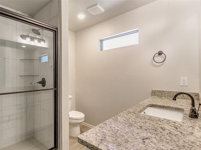 9070 Oak Tree Cir, Edmond, OK 73025 - bathroom with vanity, a stall shower, and wood finished floors