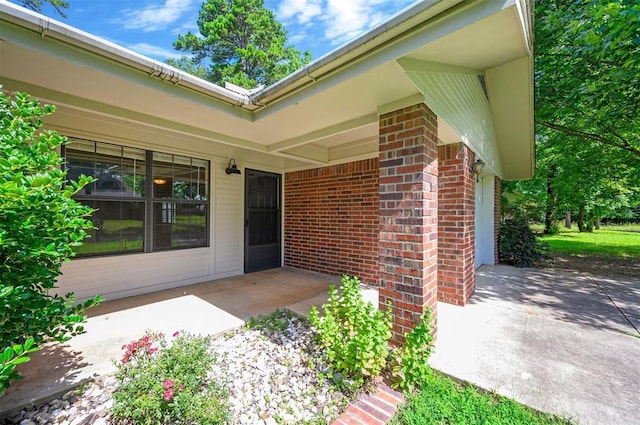 1001 Norris Ave, Broken Bow, OK 74728 - doorway to property featuring brick siding and a patio area