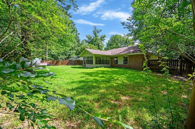 1001 Norris Ave, Broken Bow, OK 74728 - fenced backyard featuring a sunroom