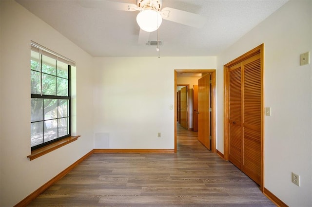 1001 Norris Ave, Broken Bow, OK 74728 - spare room featuring wood finished floors and a ceiling fan
