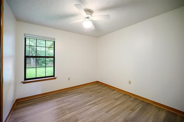 1001 Norris Ave, Broken Bow, OK 74728 - unfurnished room with wood finished floors, a ceiling fan, and a textured ceiling