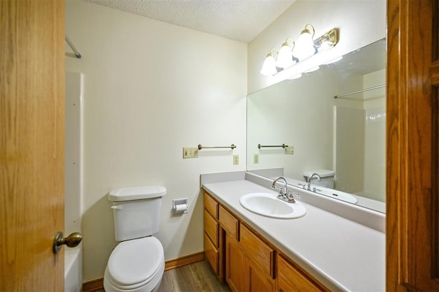 1001 Norris Ave, Broken Bow, OK 74728 - full bathroom with a textured ceiling, wood finished floors, and vanity