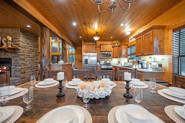 25 Paint Horse Cir, Broken Bow, OK 74728 - dining room featuring wooden ceiling, recessed lighting, a chandelier, wood-type flooring, and a stone fireplace