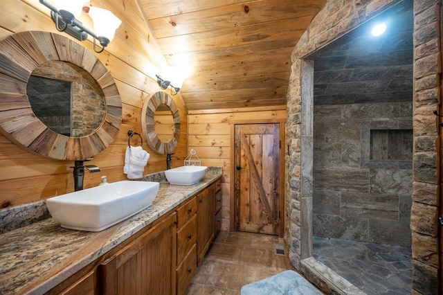 25 Paint Horse Cir, Broken Bow, OK 74728 - bathroom featuring wood ceiling, double vanity, a tile shower, wood walls, and stone finish flooring