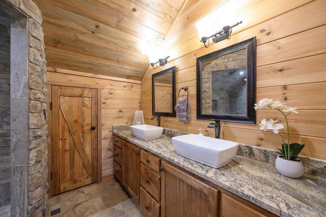 25 Paint Horse Cir, Broken Bow, OK 74728 - bathroom featuring double vanity, lofted ceiling, wood ceiling, wooden walls, and stone finish flooring