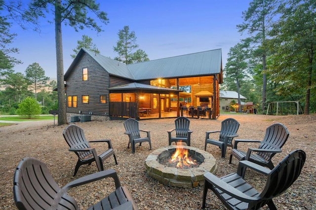 25 Paint Horse Cir, Broken Bow, OK 74728 - rear view of property featuring a fire pit, a metal roof, and log veneer siding