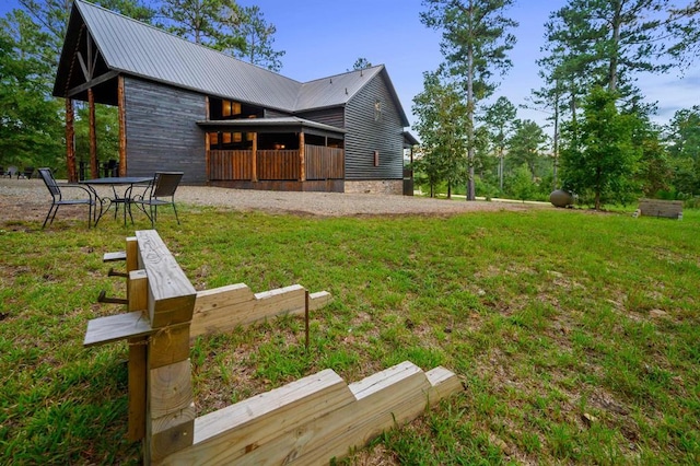 25 Paint Horse Cir, Broken Bow, OK 74728 - rear view of property with a lawn and a metal roof