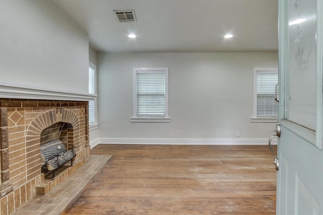 2524 NW 15th St, Oklahoma City, OK 73107 - unfurnished living room with wood finished floors, a fireplace, and recessed lighting