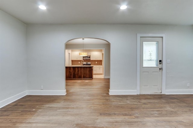 2524 NW 15th St, Oklahoma City, OK 73107 - entryway with arched walkways, light wood finished floors, and recessed lighting