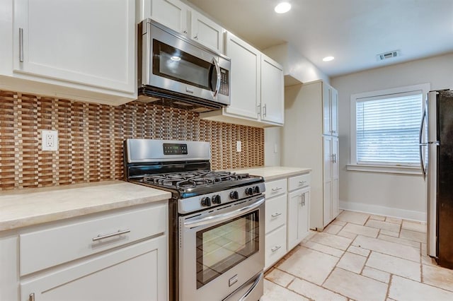 2524 NW 15th St, Oklahoma City, OK 73107 - kitchen with stainless steel appliances, tasteful backsplash, white cabinets, light countertops, and recessed lighting