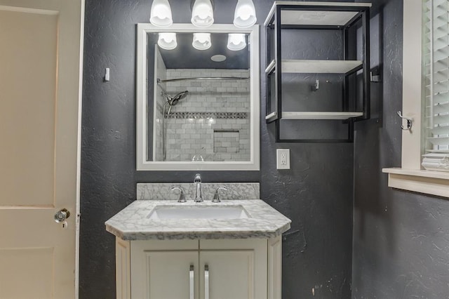2524 NW 15th St, Oklahoma City, OK 73107 - full bath featuring a textured wall, vanity, and a shower