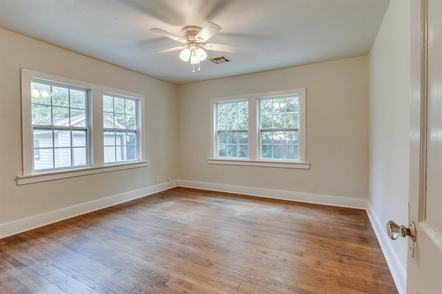 2524 NW 15th St, Oklahoma City, OK 73107 - unfurnished room featuring plenty of natural light, wood finished floors, and ceiling fan