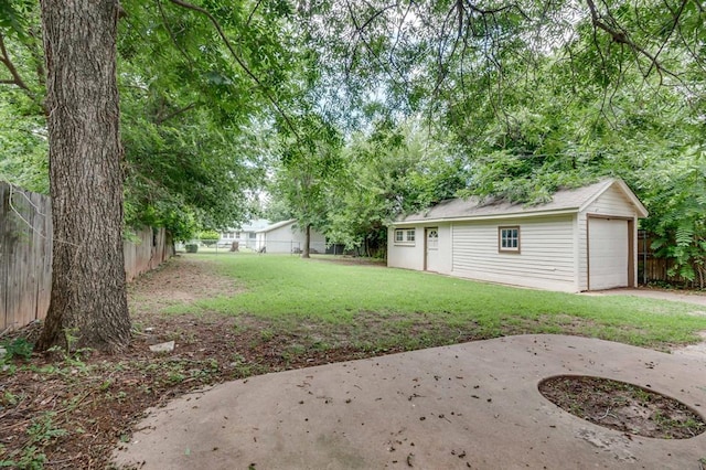2524 NW 15th St, Oklahoma City, OK 73107 - fenced backyard featuring an outbuilding, a detached garage, and concrete driveway
