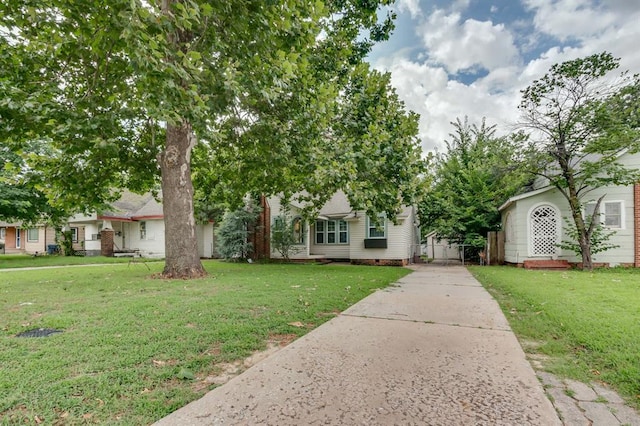 2524 NW 15th St, Oklahoma City, OK 73107 - view of property hidden behind natural elements featuring concrete driveway and a front yard