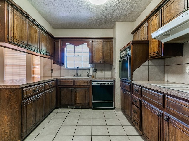 14601 Prairie Ln, Oklahoma City, OK 73165 - kitchen featuring black appliances, exhaust hood, a textured ceiling, backsplash, and a peninsula