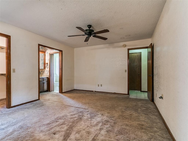 14601 Prairie Ln, Oklahoma City, OK 73165 - spare room featuring ceiling fan, light colored carpet, a textured ceiling, and a textured wall